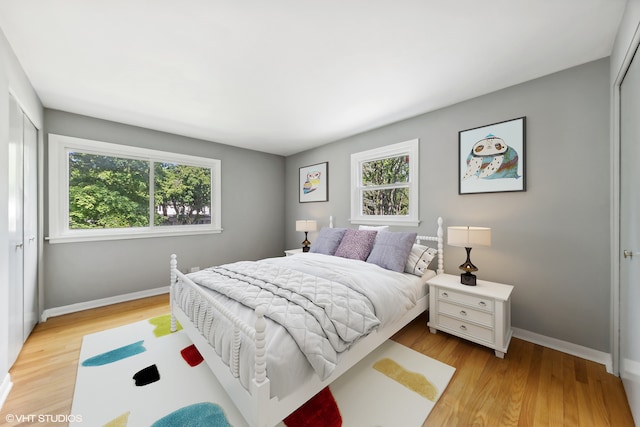 bedroom with a closet and light hardwood / wood-style floors