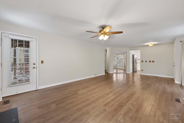 unfurnished living room featuring ceiling fan and wood-type flooring