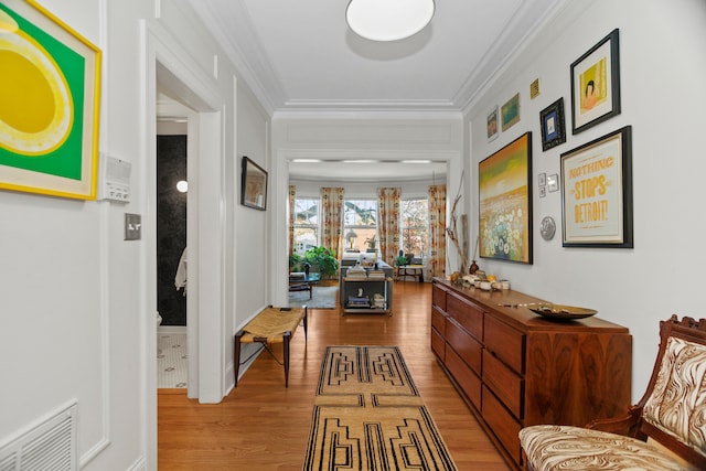 hallway featuring light hardwood / wood-style flooring and ornamental molding