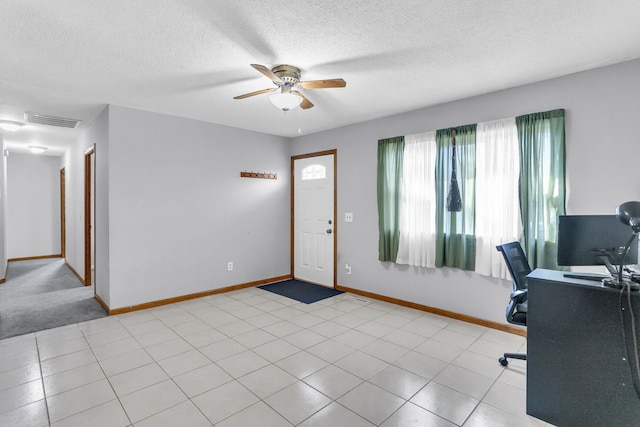 office space featuring light tile patterned floors, a textured ceiling, and ceiling fan