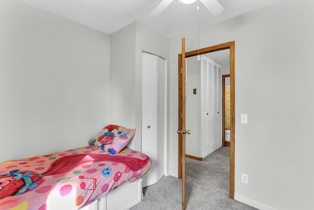 bedroom featuring ceiling fan, light carpet, and a closet