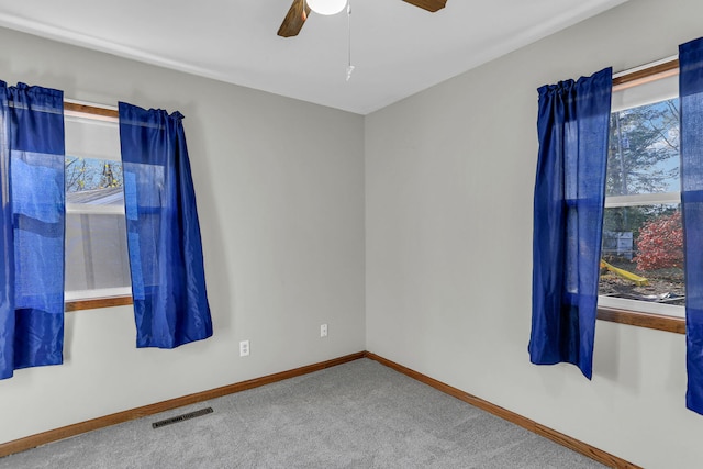 spare room featuring carpet flooring and ceiling fan