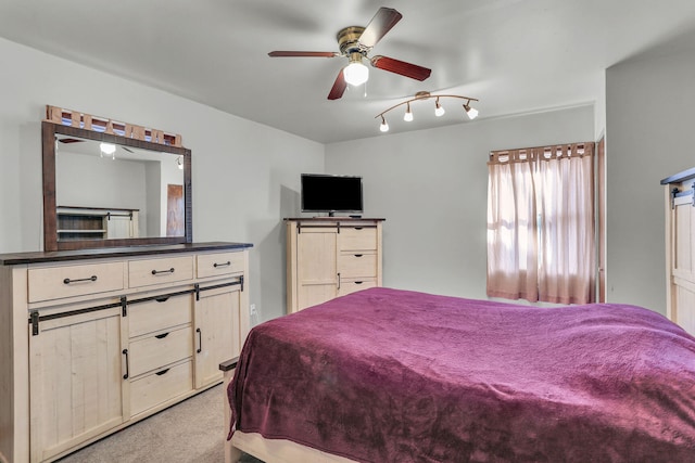 bedroom with ceiling fan and light carpet