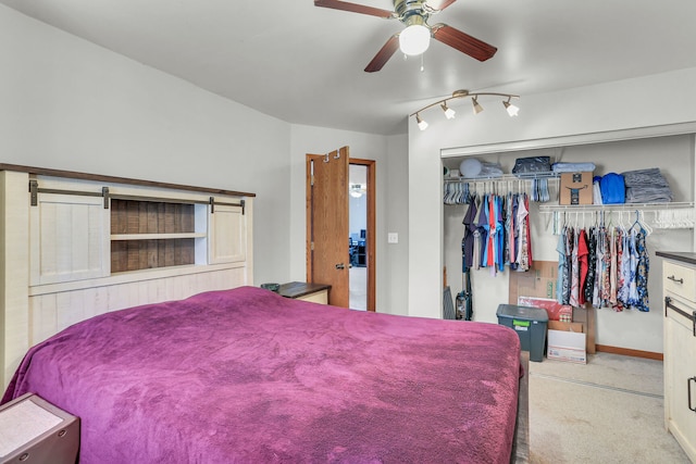 carpeted bedroom featuring ceiling fan and a closet