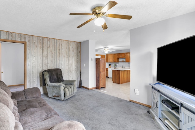 carpeted living room with a textured ceiling and wood walls