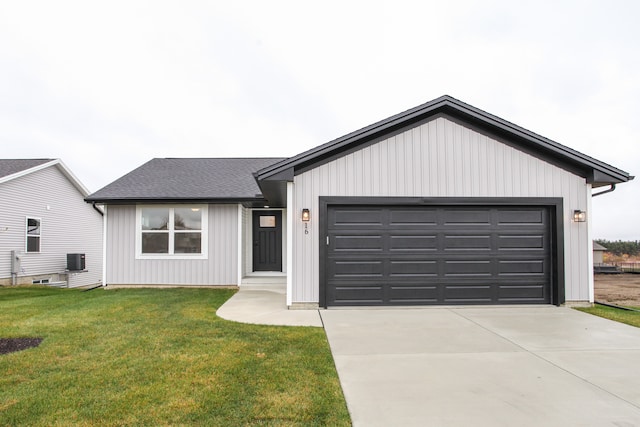 view of front of house featuring a front lawn, a garage, and central AC