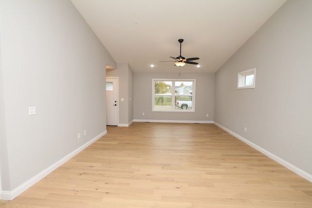 unfurnished living room with light wood-type flooring, ceiling fan, and vaulted ceiling