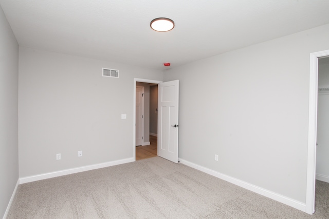 unfurnished bedroom with light colored carpet