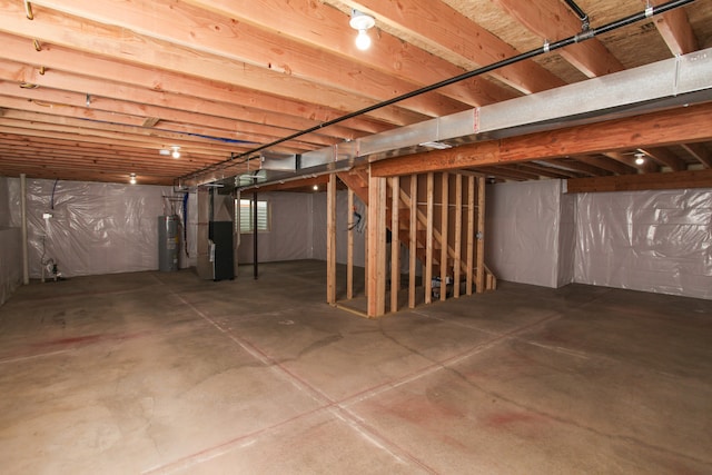 basement featuring water heater and heating unit