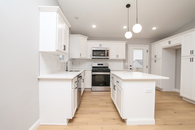 kitchen featuring white cabinets, sink, light hardwood / wood-style floors, and stainless steel appliances