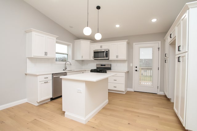 kitchen with white cabinets, light hardwood / wood-style floors, and stainless steel appliances