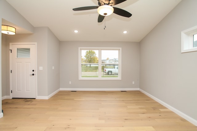 foyer featuring ceiling fan, light wood-type flooring, and lofted ceiling