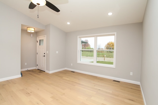 empty room featuring light hardwood / wood-style floors, ceiling fan, and lofted ceiling