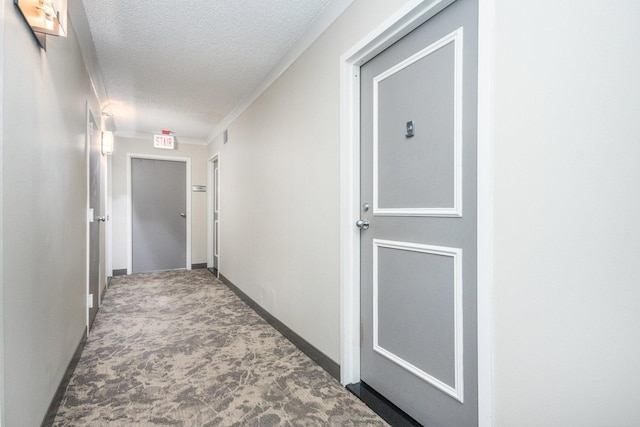 hall featuring a textured ceiling and carpet flooring