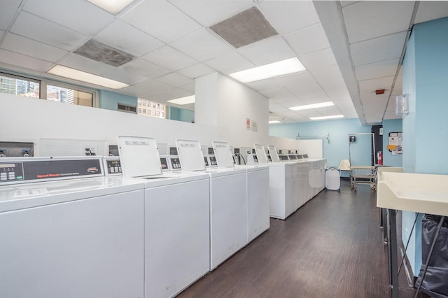 laundry room featuring independent washer and dryer and dark hardwood / wood-style flooring