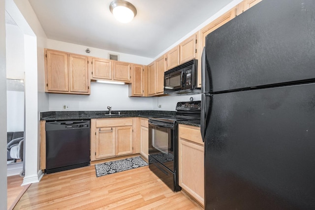 kitchen with light brown cabinetry, sink, light hardwood / wood-style flooring, and black appliances