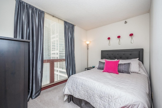 carpeted bedroom with a textured ceiling