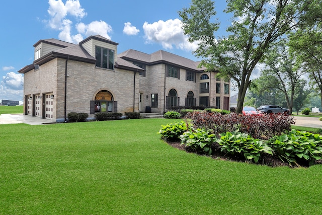 view of front of house with a garage and a front lawn