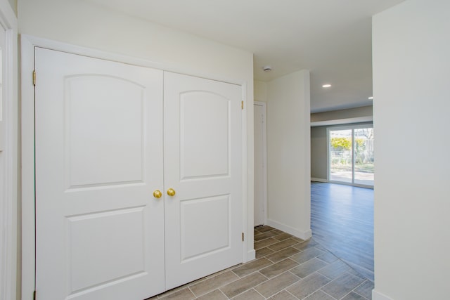 hallway with light hardwood / wood-style floors