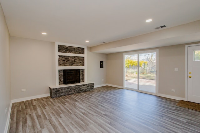 unfurnished living room featuring light hardwood / wood-style floors and a fireplace