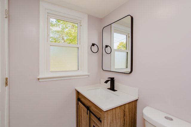 bathroom featuring vanity and toilet