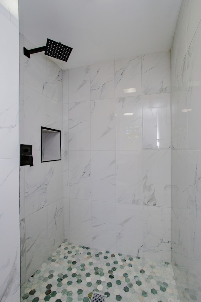 bathroom with a tile shower