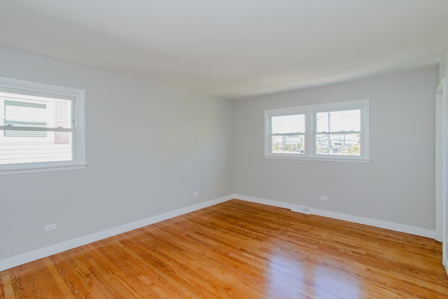 spare room with light hardwood / wood-style floors