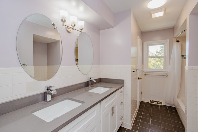 bathroom with tile patterned floors, vanity, a shower with curtain, and tile walls