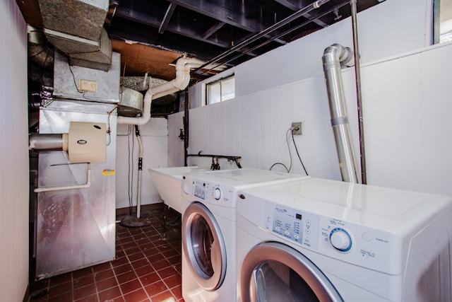 washroom featuring wooden walls and washer and dryer