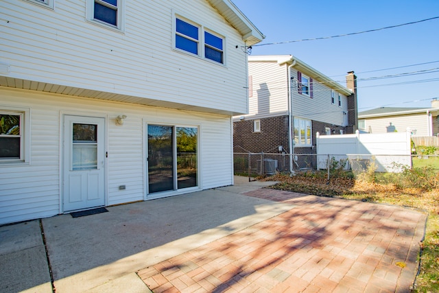 rear view of house featuring a patio area and central AC