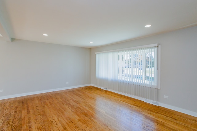 spare room with light wood-type flooring