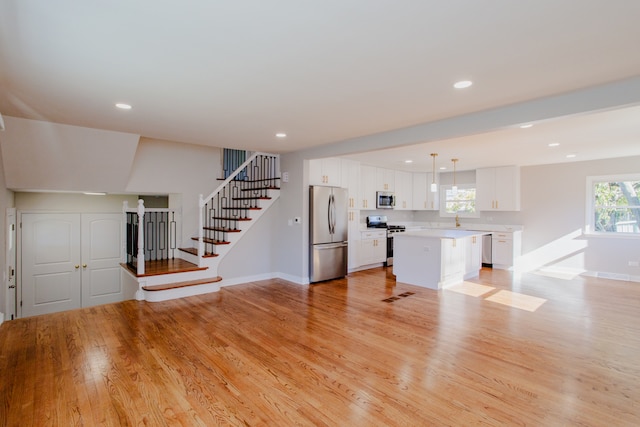 unfurnished living room featuring light hardwood / wood-style flooring