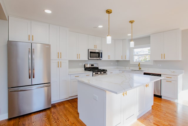 kitchen with white cabinets, appliances with stainless steel finishes, and a center island