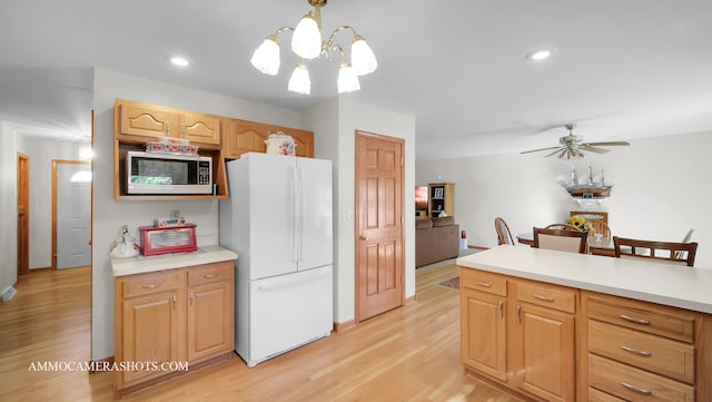 kitchen featuring ceiling fan with notable chandelier, hanging light fixtures, light hardwood / wood-style floors, white refrigerator, and light brown cabinets