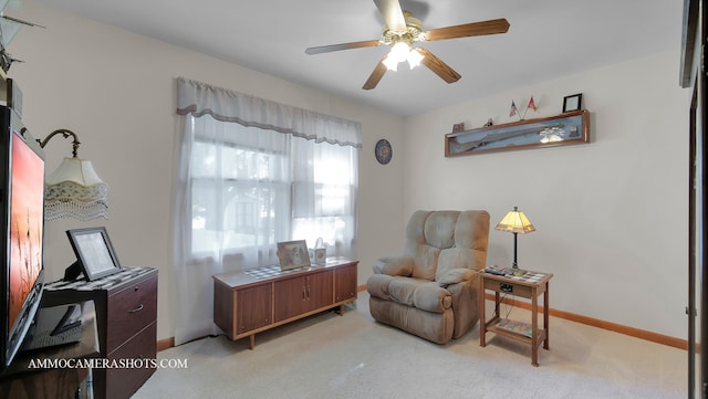 sitting room featuring ceiling fan and light colored carpet