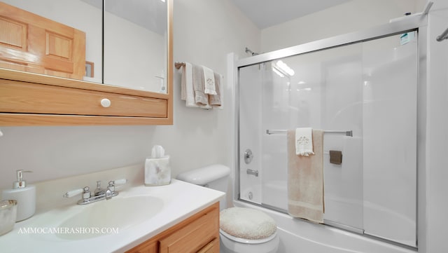 full bathroom with vanity, enclosed tub / shower combo, and toilet