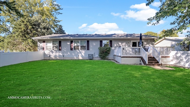 back of house with a wooden deck, cooling unit, and a lawn