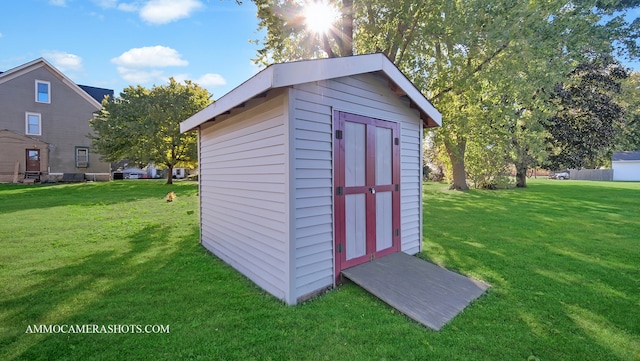 view of outbuilding with a lawn