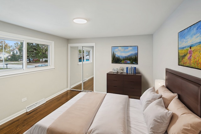 bedroom with dark wood-type flooring