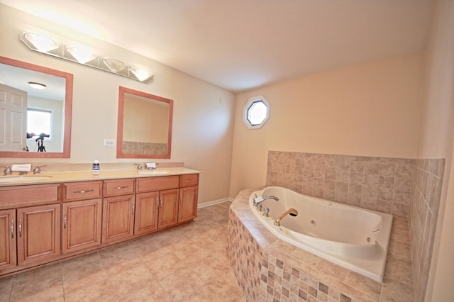 bathroom featuring tile patterned flooring, vanity, and tiled tub