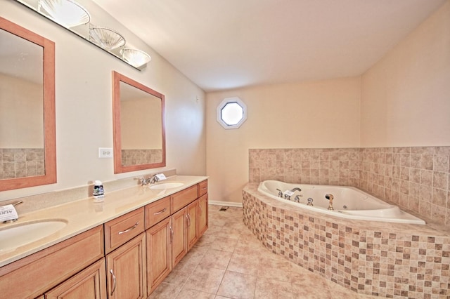 bathroom featuring tile patterned floors, tiled bath, and vanity