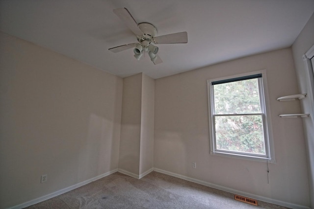 spare room with light colored carpet and ceiling fan