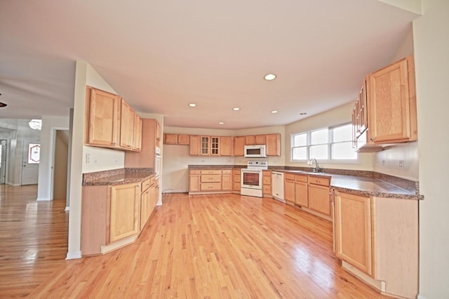 kitchen featuring light brown cabinets, white appliances, sink, and light hardwood / wood-style flooring