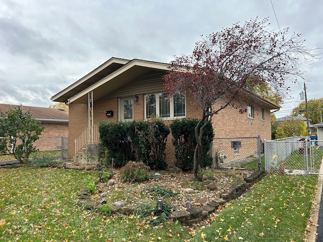 view of side of home featuring a lawn