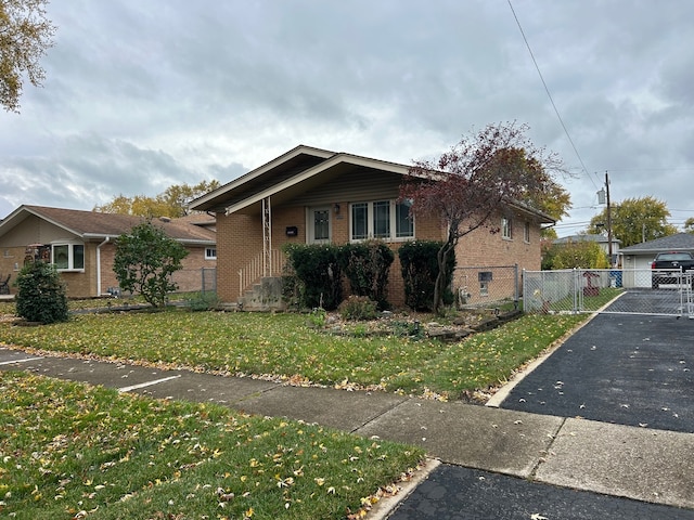 bungalow-style home with a front lawn