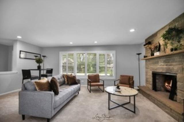 living room with light carpet and a fireplace