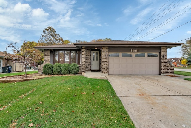 view of front facade with a front yard and a garage