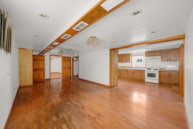 unfurnished living room with light hardwood / wood-style floors and a barn door