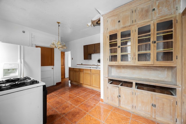 kitchen with tile patterned flooring, a chandelier, sink, pendant lighting, and white appliances