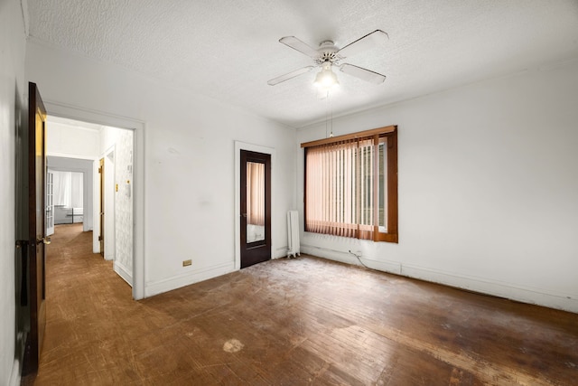 unfurnished bedroom featuring dark wood-type flooring, radiator, a textured ceiling, and ceiling fan